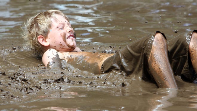 Michael Bonelli plays in the mud during the third annual Mess Fest in honor of Ty Louis Campbell at Camp Kiwi in Mahopac Aug. 8, 2015. Young Ty lost a courageous battle with cancer a few years ago. The Ty Louis Campbell (TLC) Foundation was created in his honor to raise awareness for pediatric cancer.