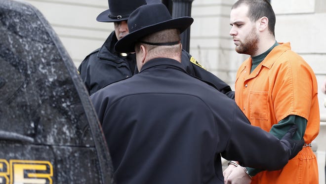 Lawrence K. Baker, 24, is ushered into the back seat of a Chemung County Sheriff's vehicle as he leaves  City of Elmira Court following an appearance Feb. 19.