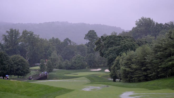Golfers head back to the clubhouse Monday, July 15 evening after play in a sectional qualifier for the U.S. Amateur was suspended a second time due to storms in the vicinity of Trump National-Westchester. Play is schedule to resume at 8:30 a.m. on Tuesday.