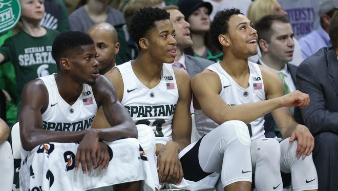 From left, Michigan State's Eron Harris, Deyonta Davis and Bryn Forbes watch the second half against Rutgers on Sunday, Jan. 31, 2016, at the Breslin Center in East Lansing.