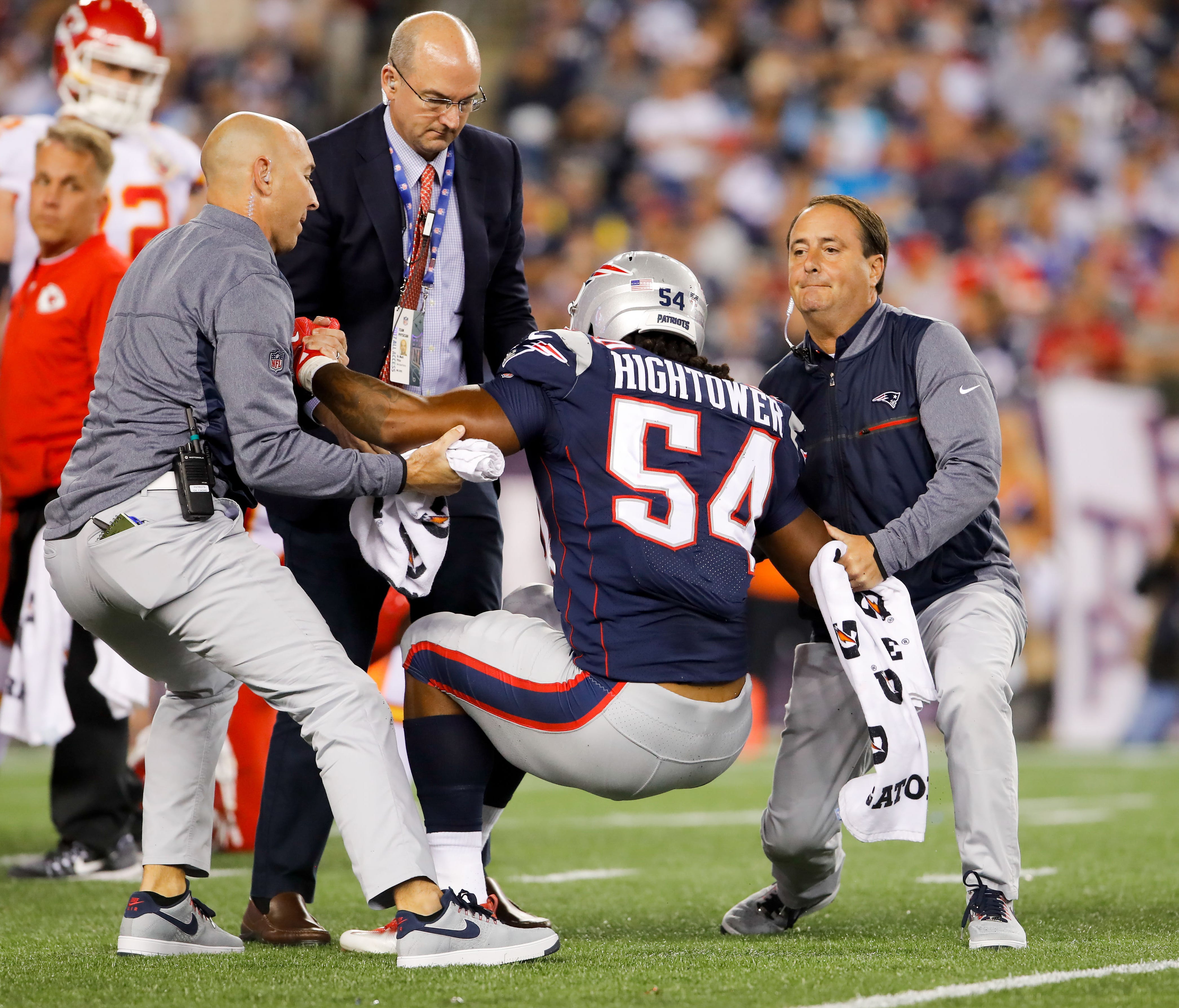 Trainers help New England Patriots middle linebacker Dont'a Hightower (54) off of the field after an injury during the third quarter at Gillette Stadium.
