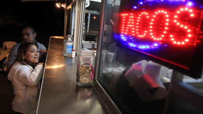 Haydee Muniz (left) and Luis Tello wait for their order Thursday, Nov. 15, 2012 at the Fiesta Tacos and More food truck on the corner of Port Avenue and Baldwin Boulevard in Corpus Christi.