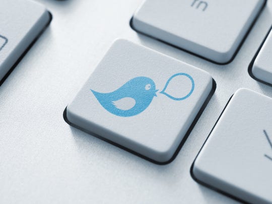 The blue Twitter bird icon imprinted on the key of a computer keyboard