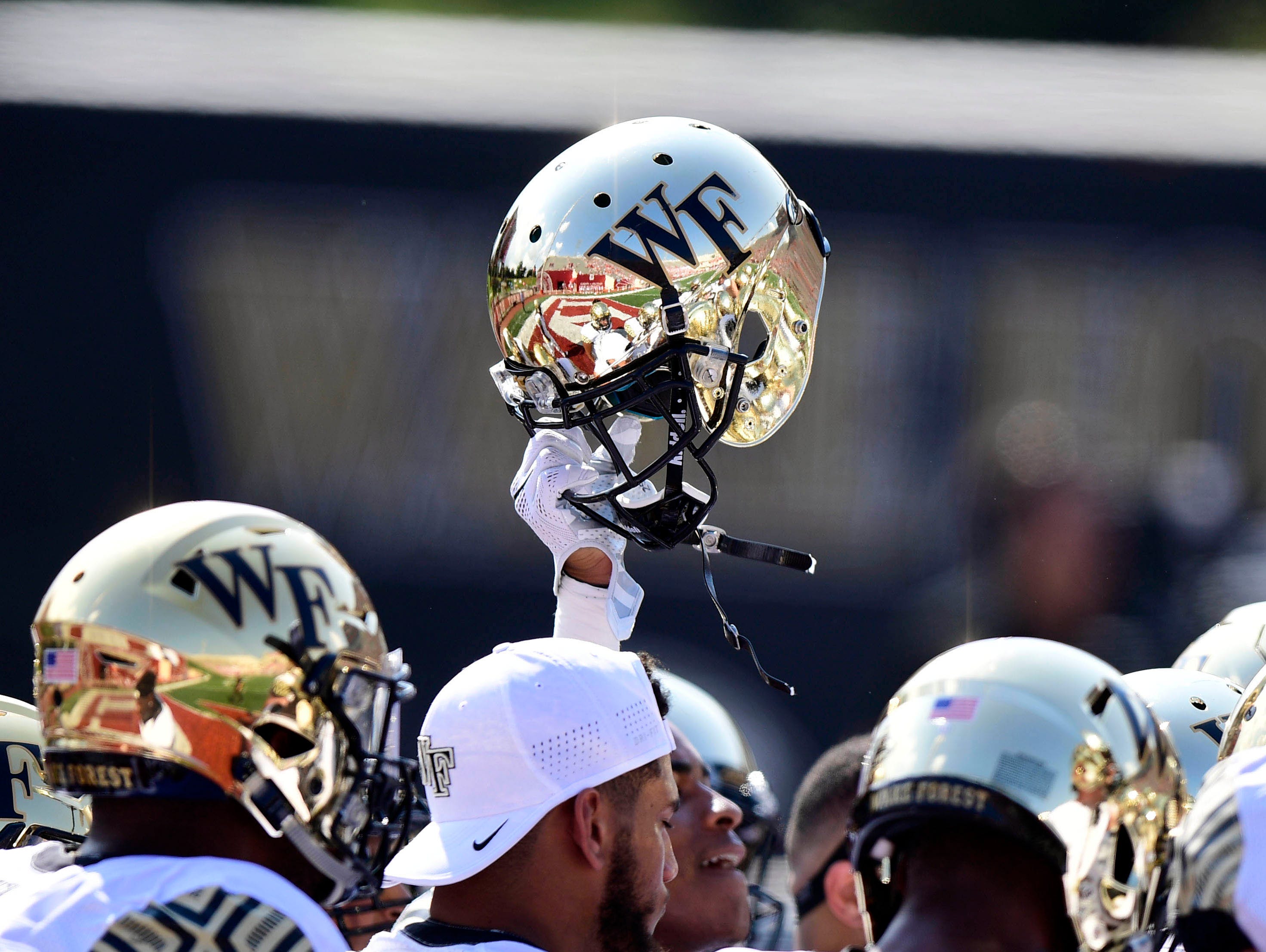 Memorial Stadium reflects in the helmet of a Wake Forest Demon Deacons.