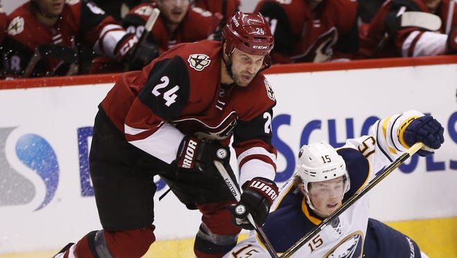 Arizona Coyotes center Kyle Chipchura (24) takes the puck from Buffalo Sabres center Jack Eichel (15) during the second period at Gila River Arena in Glendale, Ariz. January 18, 2016.