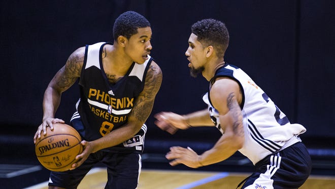Tyler Ulis, left, and Askia Booker, Colorado, square off during Phoenix Suns Summer League at Talking Stick Resort Arena in Phoenix, Friday, July 8, 2016.