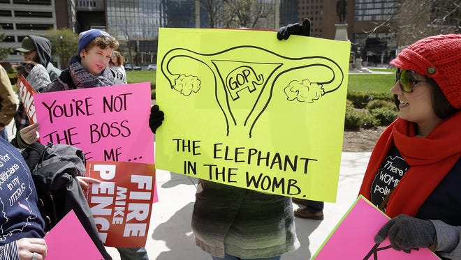 Thousands rally for women's rights on the south lawn of the Indiana State House on April 9, 2016. The rally, in response to a controversial new Indiana abortion bill, is designed to bring together women and the men who support them who all believe that women should have the right to decide what to do with their bodies without government intrusion.