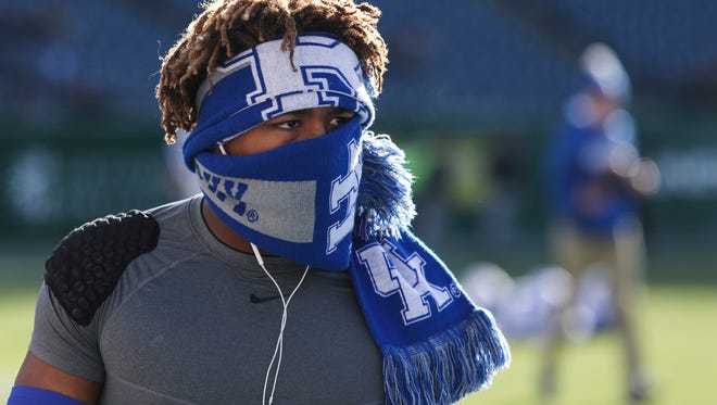 UK football player Benny Snell, Jr. stays warm at Nissan Stadium before the start of the Music City Bowl between the University of Kentucky and Northwestern University. Dec. 29, 2017