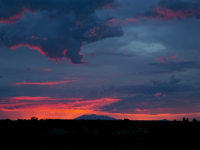 The San Francisco Peaks are seen in the distance as