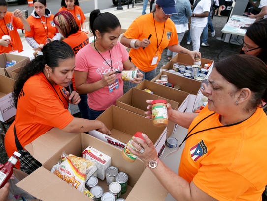Volunteers sort through donations of food, medicine