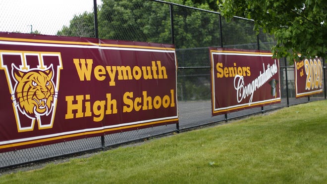 Signs celebrating the Weymouth High Class of 2020 hang outside the school on Pleasant Street on Sunday June 7, 2020.