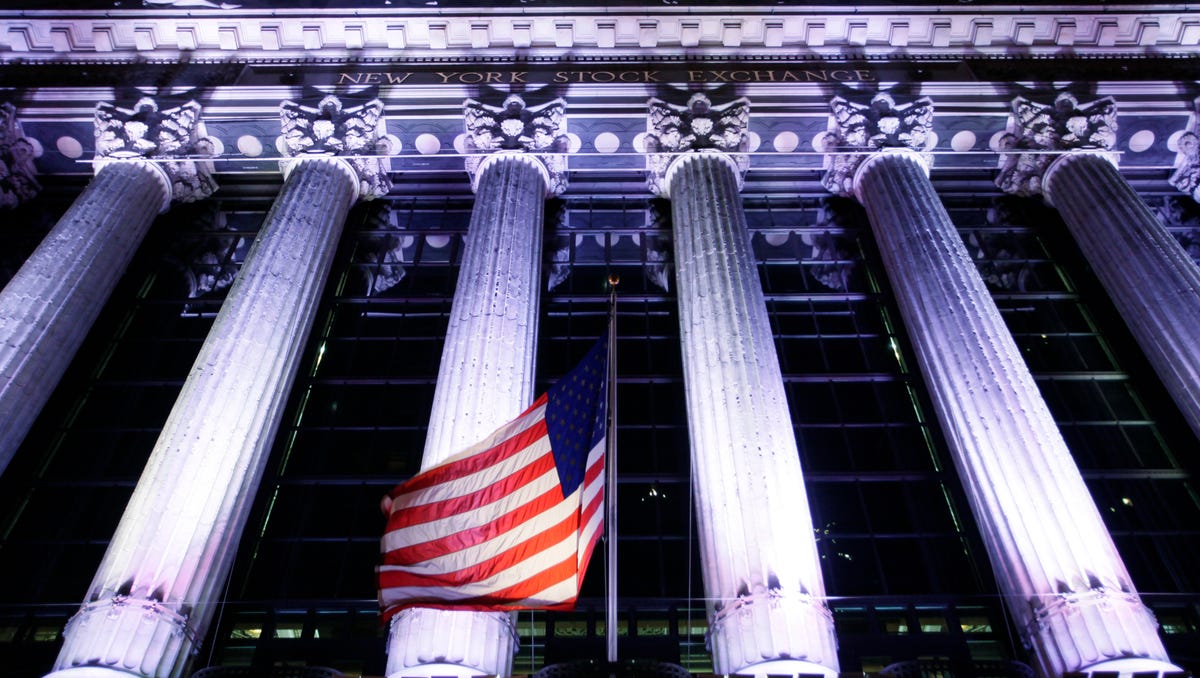 In this Oct. 8, 2014, file photo, an American flag flies in front of the New York Stock Exchange in New York.