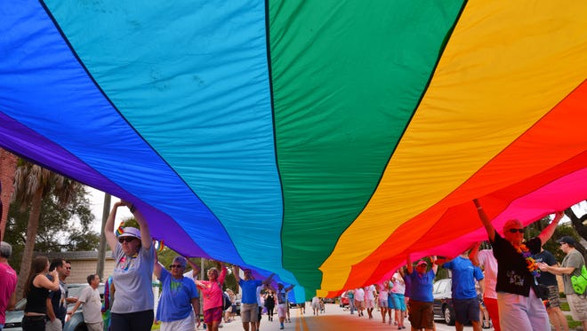 A 100-foot section of the "sea-to-sea" rainbow flag is carried along the parade at the eighth-annual Space Coast Pride Festival in the Eau Gallie Arts District. The 2017 Space Coast Pride Festival & Parade will be receiving marketing support through a Space Coast Office of Tourism program.