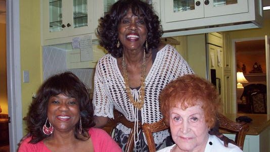 Jewell McMahan (right) sits with Ella Gaston's daughters, Voncille (left) and Jean (middle).