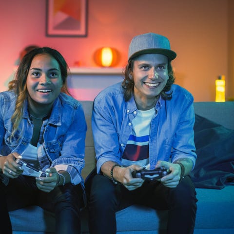 Two friends playing console games together.