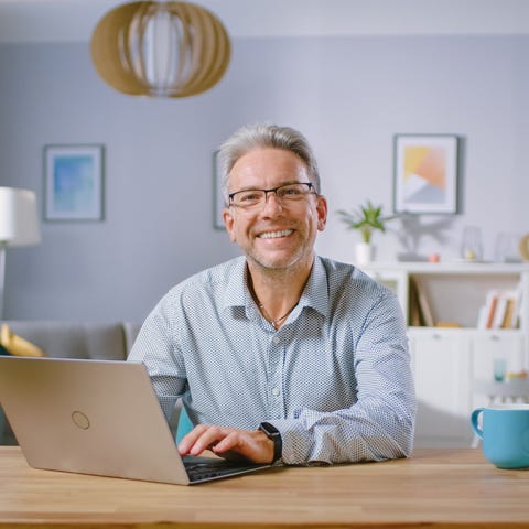 A person at a laptop smiling.