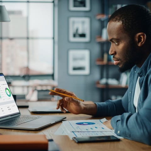 Person reviewing charts on a laptop.