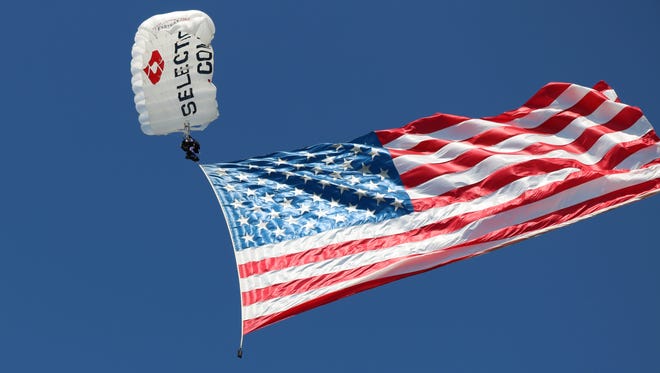 A skydiver from Team Fastrax takes part in a patriotic display honoring veterans and Gold Star families at the Walleyes for Wounded Heroes finale.