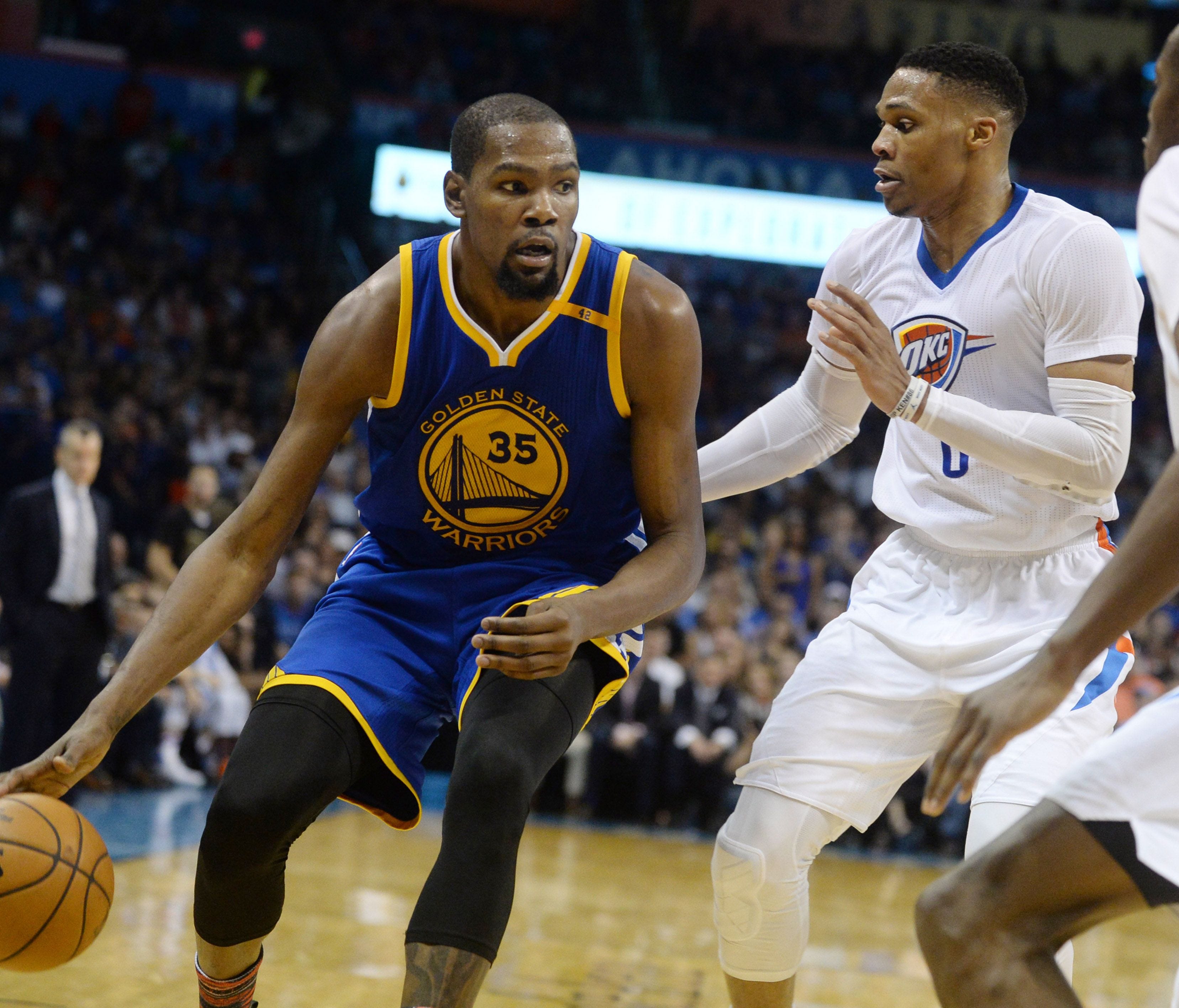Golden State Warriors forward Kevin Durant fights for position with Oklahoma City Thunder guard Russell Westbrook during the second quarter at Chesapeake Energy Arena.
