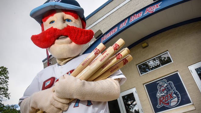 St. Cloud Rox mascot Chisel holds an armful of promotional bats in preparation for the upcoming season Friday, May 25, at Joe Faber Field in St. Cloud. 