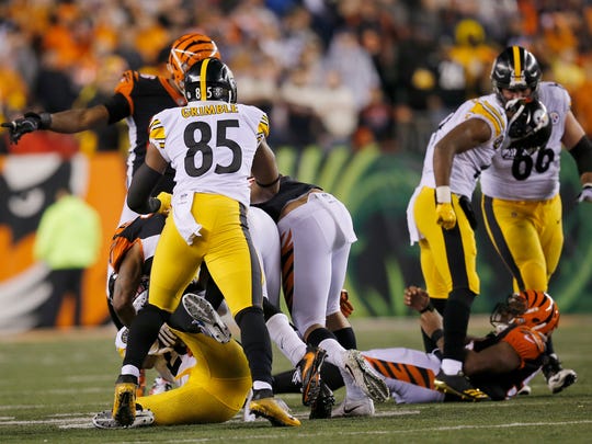 Pittsburgh Steelers wide receiver JuJu Smith-Schuster (19) stands over a motionless Cincinnati Bengals outside linebacker Vontaze Burfict (55) after making hard helmet to helmet contact on a block in the fourth quarter of the NFL Week 13 game between the Cincinnati Bengals and the Pittsburgh Steelers at Paul Brown Stadium in downtown Cincinnati on Tuesday, Dec. 5, 2017. The Bengals gave up a 17-3 halftime lead to lose 23-20 on a last-second field goal. 