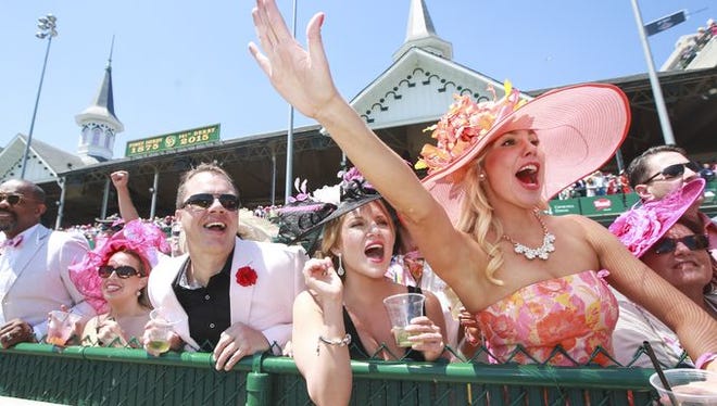 Heather Merten, from right, Laura Cessna, Chuck Marksbury and Savannah Moroz cheer during the finish of The La Troienne race at the Kentucky Oaks on Friday. May 1, 2015  Alton Strupp/The Courier-Journal