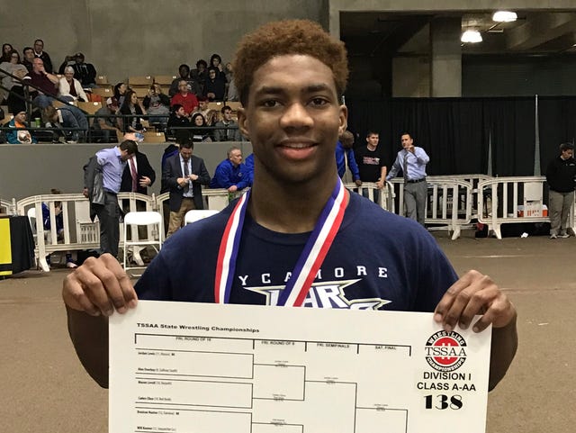 Sycamore's Tyree Bass holds up a bracket showing his