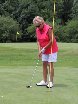 Gardner Women's Golf Association president Judy Walker putts on the 18th green during last week's Worcester County Women's Golf Association tournament at Gardner Municipal Golf Course.
