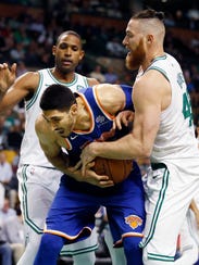 Celtics' Aron Baynes, right, tries to strip the ball from the Knicks' Enes Kanter on Oct. 24.
