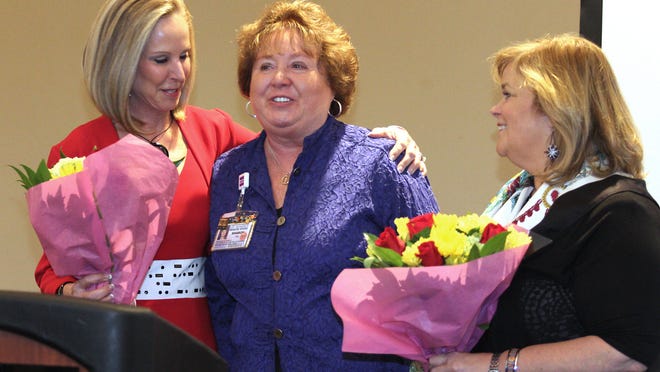 Elaine Haw­kins, president of SWFL Children’s Charities, Sharon MacDonald of Lee Memorial Health Systems and Dorothy Fitzgerald of Southwest Florida Wine & Food Fest, address the crowd.