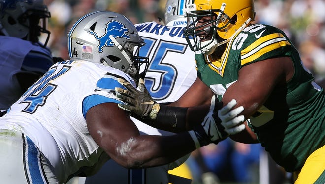 Michael Ola, left, of the Detroit Lions blocks  Datone Jones of the Green Bay Packers in the second quarter at Lambeau Field on Nov. 15, 2015, in Green Bay, Wisconsin.