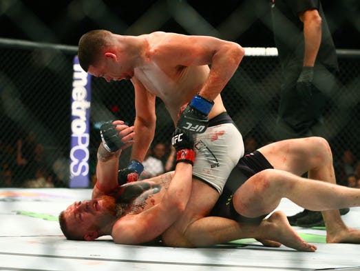 Nate Diaz (top) against Conor McGregor during UFC 196