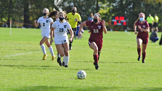 Bishop Stang's Kate Carreau inches ahead of Austin Prep chasing down the ball on Saturday. The match ended in a 0-0 tie.