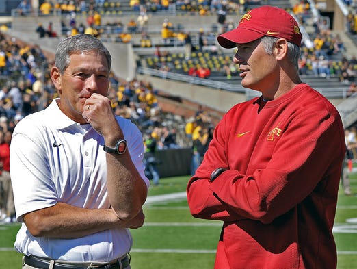 Iowa head football coach Kirk Ferentz, left, talked with Iowa State head coach Paul Rhoades before football game at Kinnick Stadium in Iowa City on Saturday Sept. 13, 2014.