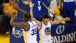 Stephen Curry celebrates with Kevin Durant during the