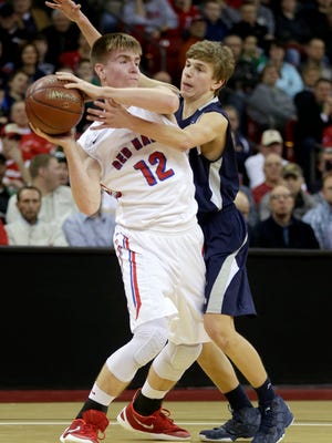 Xavier's Sam Ferris (right) defends Gale-Ettrick-Trempealeau's Chris Thompson during Thursday's WIAA Division 3 boys' state basketball semifinal at the Kohl Center in Madison.