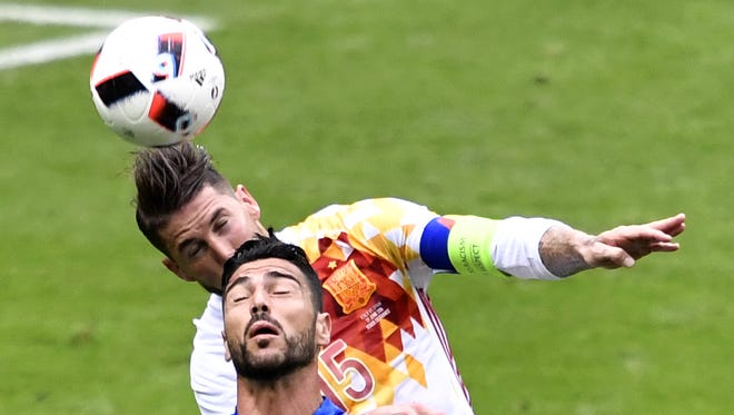 Sergio Ramos, left, and Spain were eliminated Monday by Alessandro Florenzi and Italy.