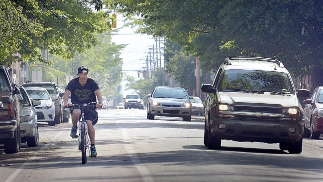 Nelson Valentin takes advantage of the bike lane on West King Street in 2014.