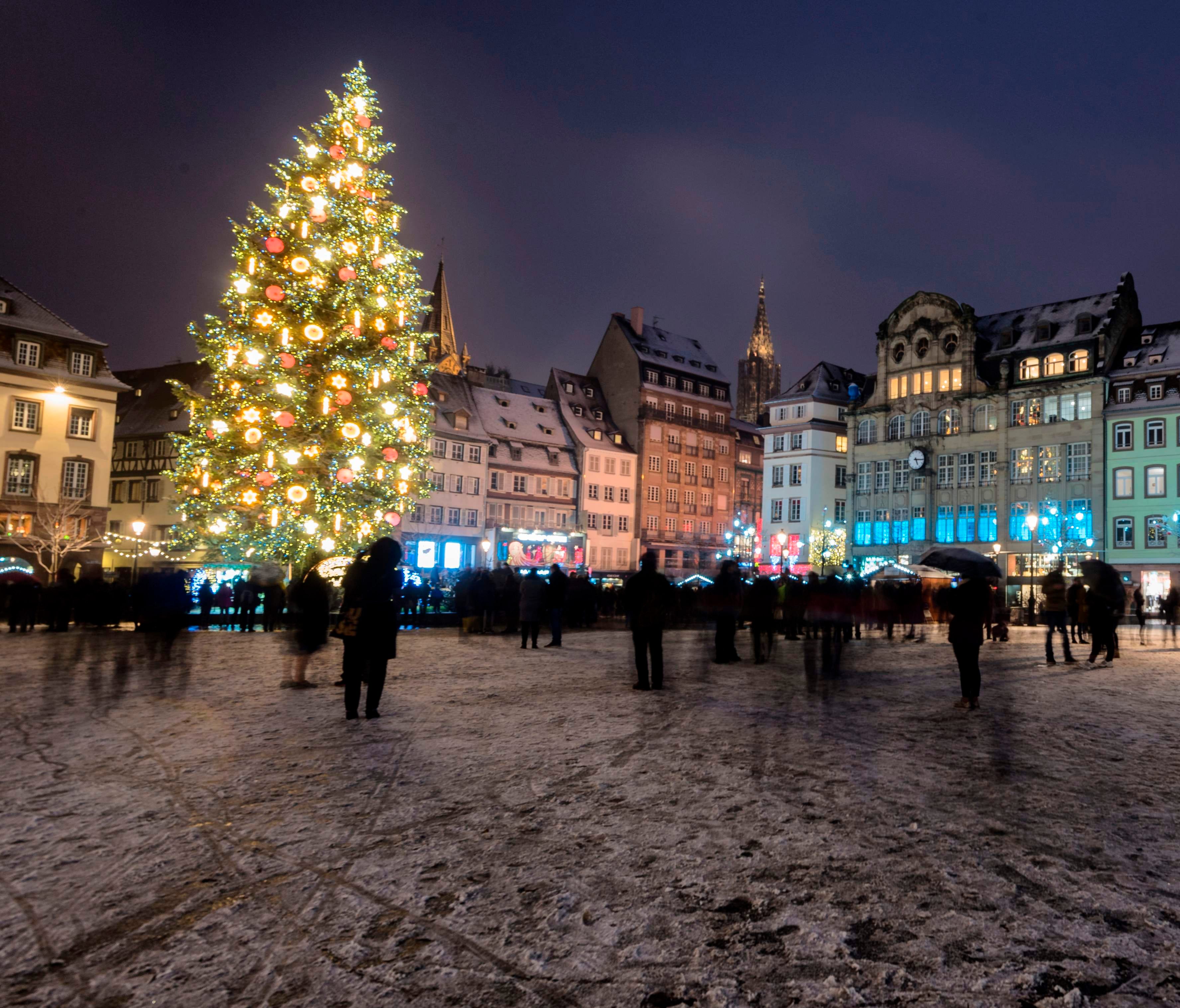 A light layer of snow covers the Place Kleber square in downtown Strasbourg, France, where a giant Christmas tree is displayed for the  2017holiday season.