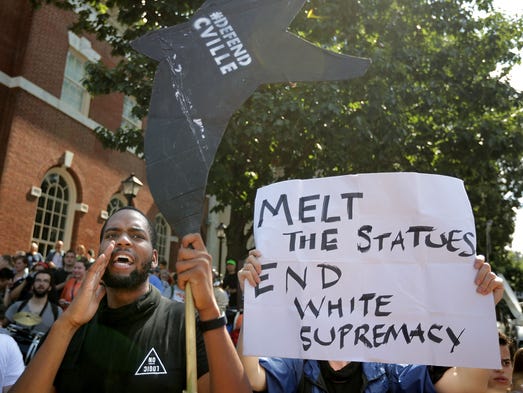  Counter-protesters line the route taken by white nationalists,