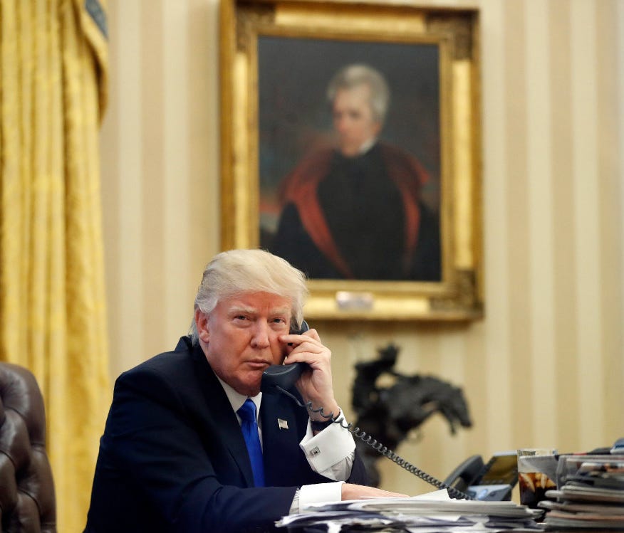 In this Jan. 28, 2017, file photo, President Trump speaks on the phone in the Oval Office of the White House.