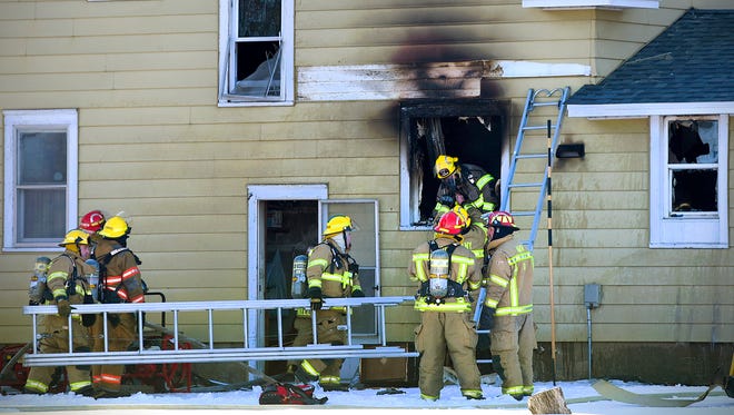 Firefighters from Avon, Albany and St. Joseph work to save a home during a fire Tuesday, Feb. 9. in Avon.