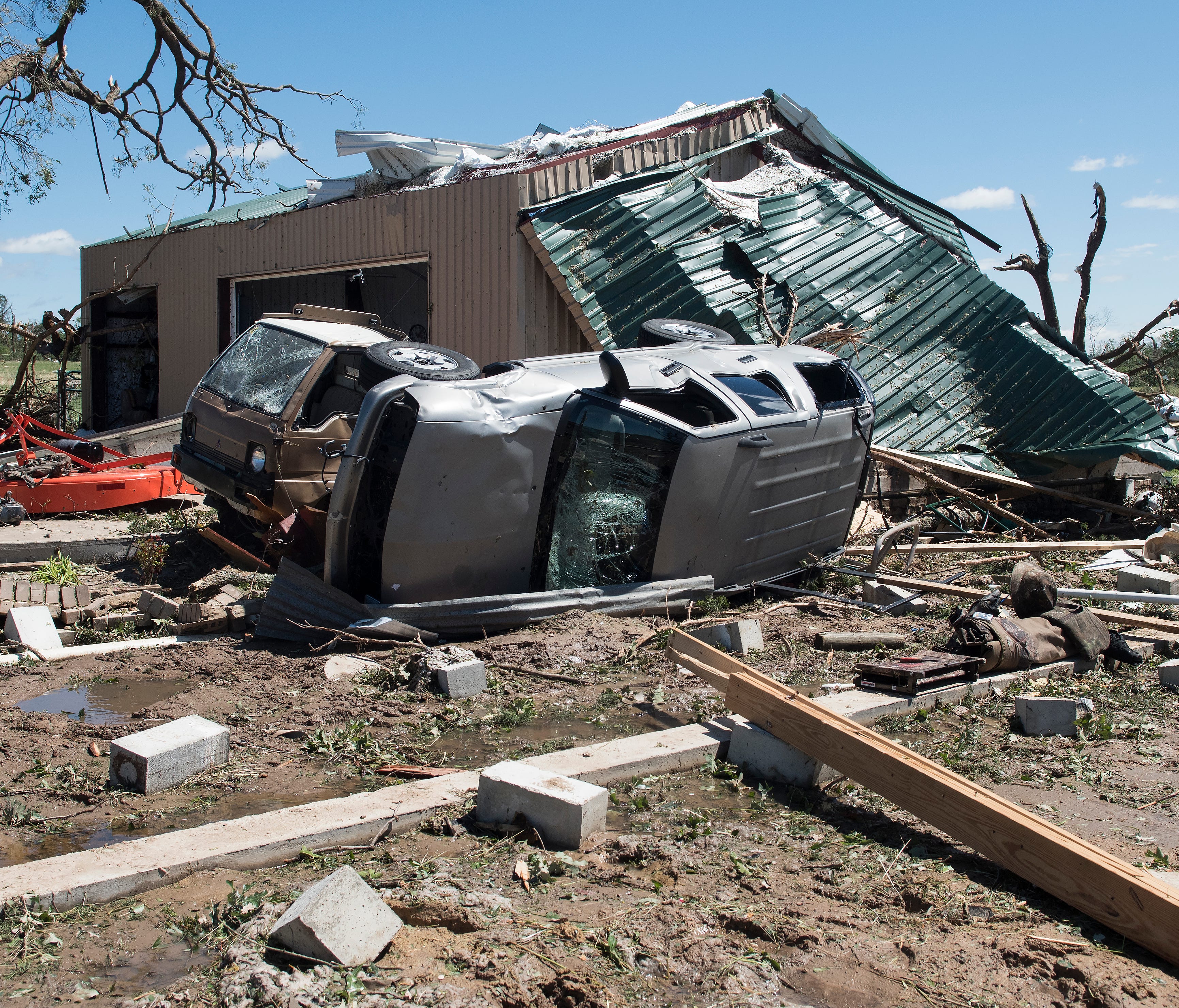 An overturned vehicle rests on the ground surrounded by debris in Canton, Texas, on Sunday after tornadoes hit the area.