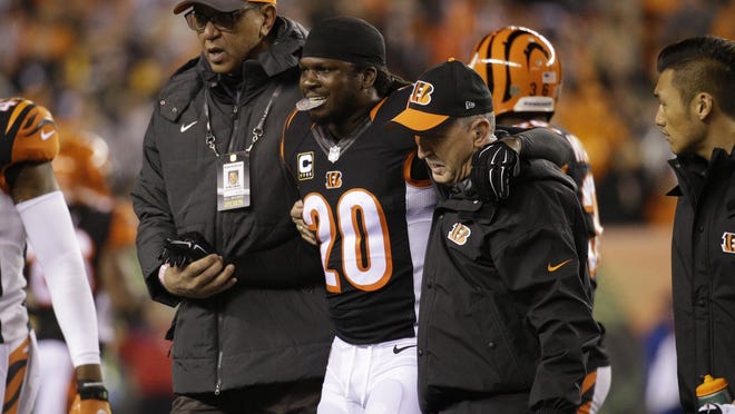 Cincinnati Bengals free safety Reggie Nelson (20) is assisted off the field during the first half of an NFL wild-card playoff football game against the Pittsburgh Steelers Saturday, Jan. 9, 2016, in Cincinnati. (AP Photo/John Minchillo)