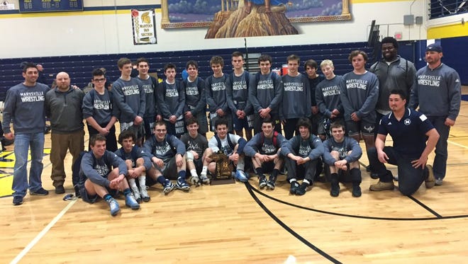 Marysville wrestling team poses with their Division 2 regional title trophy at Goodrich High School.