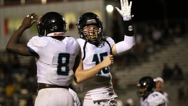 Demarcus Townsend, left and Kaden Frost celebrate the Sharks' third touchdown in the first quarter during Friday night's district game against Riverdale in Fort Myers. 