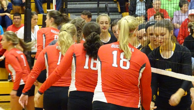 Buckeye Central and Colonel Crawford meet at the net before the match Tuesday night.