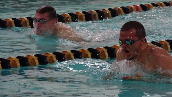 Colonel Crawford's Jake Johnson (right) and Lexington's Cayman Eichler (left) were neck and neck for most of the 100-yard breaststroke. Johnson went on to win by five seconds.