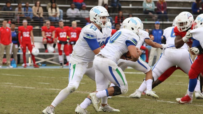 UWF quarterback Mike Beaudry hands the ball off to running back Chris Schwarz on Saturday against West Georgia in Carrollton, Georgia.