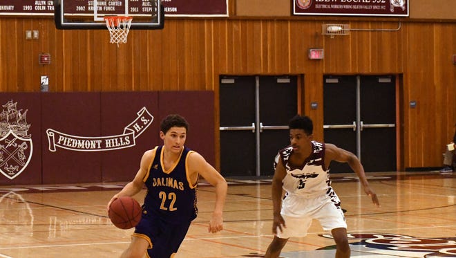 Senior guard Jarrett Edria drives to the left side on offense before passing it inside in the second quarter.